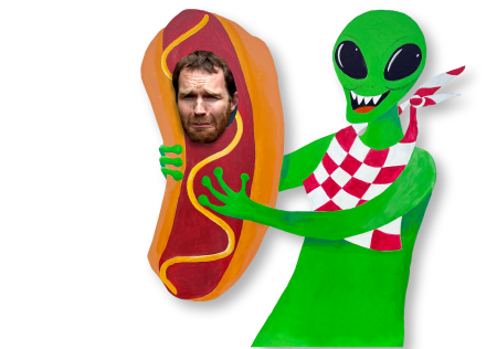 Image of alien eating a human hot dog